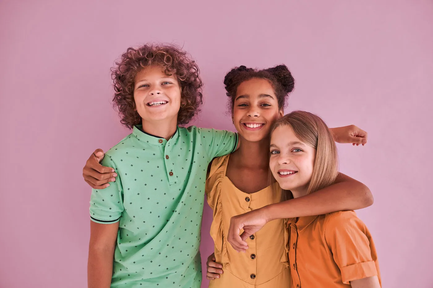 Three children with their arms around each other